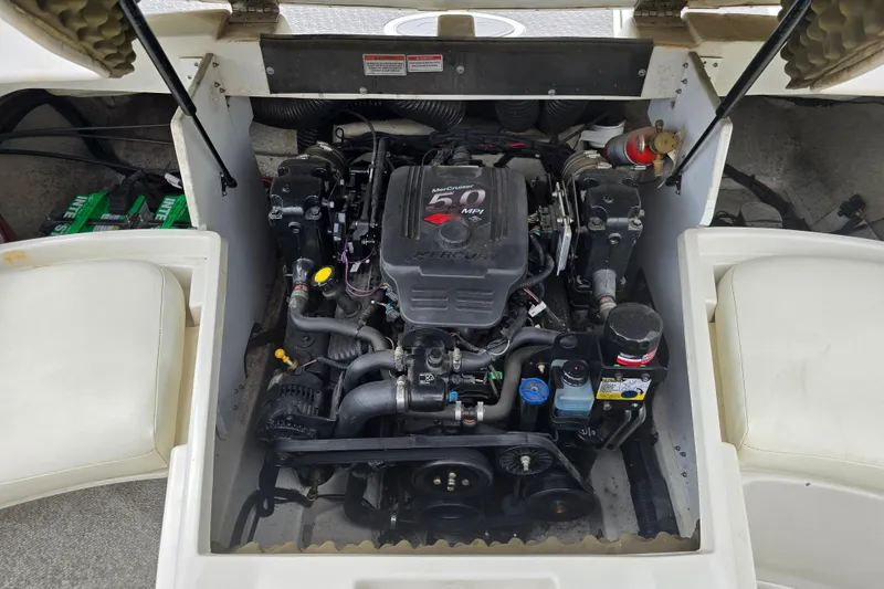 Slide: The Image of Engine compartment of a 2007 Sea Ray 210 Select boat, featuring a MerCruiser engine. - 22