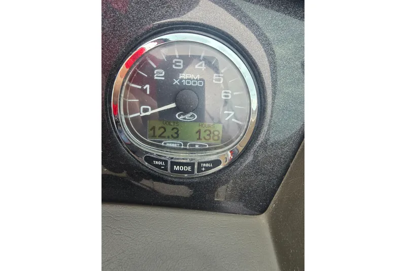 Slide: The Image of Close-up of a 2007 Sea Ray 210 Select boat tachometer displaying RPM, volts, and hours. - 23