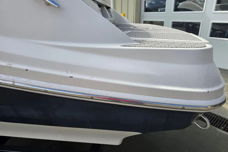 Slide: The Image of 2007 Sea Ray 210 Select boat stern with visible wear and scratches. - 25