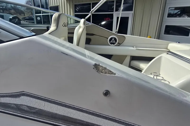 Slide: The Image of 2007 Sea Ray 210 Select boat with visible hull damage near seating area. - 26