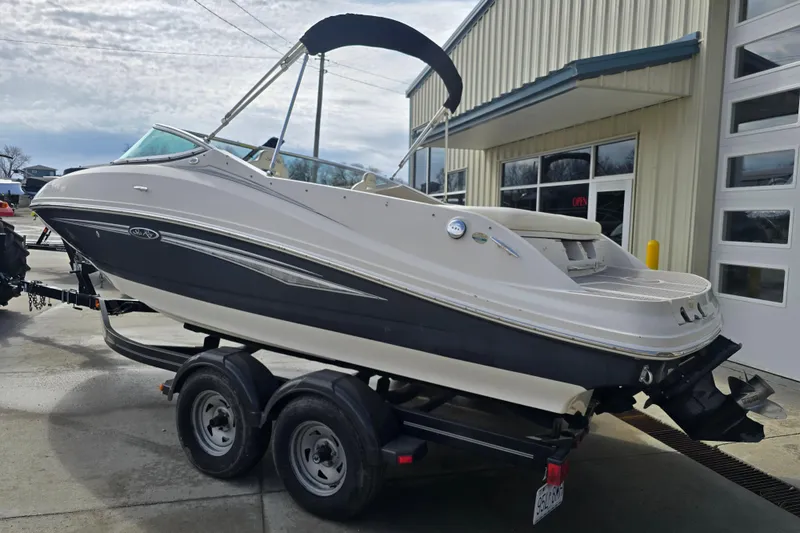 Slide: The Image of 2007 Sea Ray 210 Select boat on trailer outside a building. - 3
