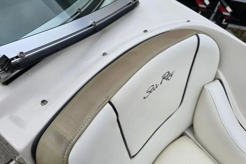 Slide: The Image of 2007 Sea Ray 210 Select boat interior with branded white seating and windshield detail. - 31