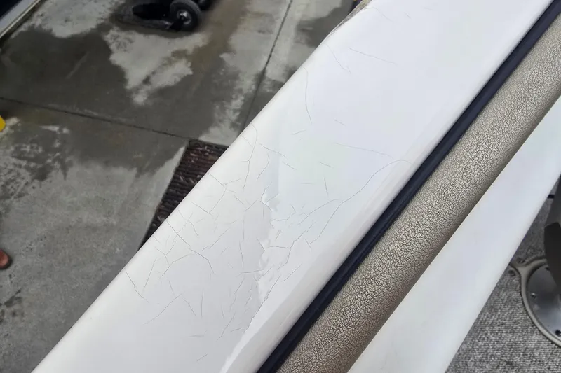 Slide: The Image of Cracked surface on 2007 Sea Ray 210 Select boat, showing wear and tear. - 33
