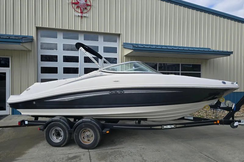 Slide: The Image of 2007 Sea Ray 210 Select boat on trailer outside a marine facility. - 7