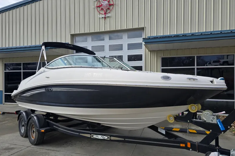 Slide: The Image of 2007 Sea Ray 210 Select boat on trailer outside a marine dealership. - 8