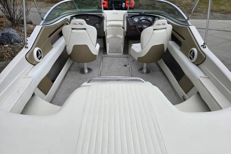 Slide: The Image of 2007 Sea Ray 210 Select boat interior with white seating and dashboard view. - 9