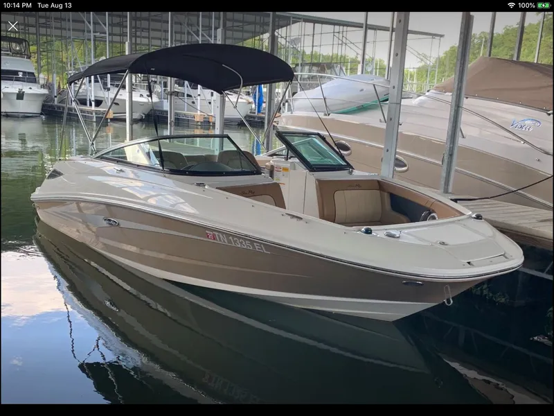 Slide: The Image of 2014 Sea Ray 220 Sundeck boat docked in marina. - 1