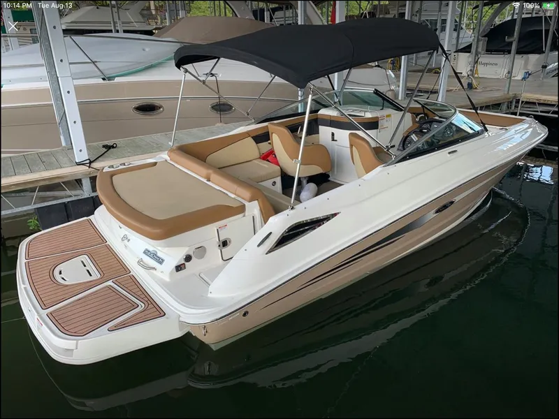 Slide: The Image of 2014 Sea Ray 220 Sundeck boat docked in marina. - 2
