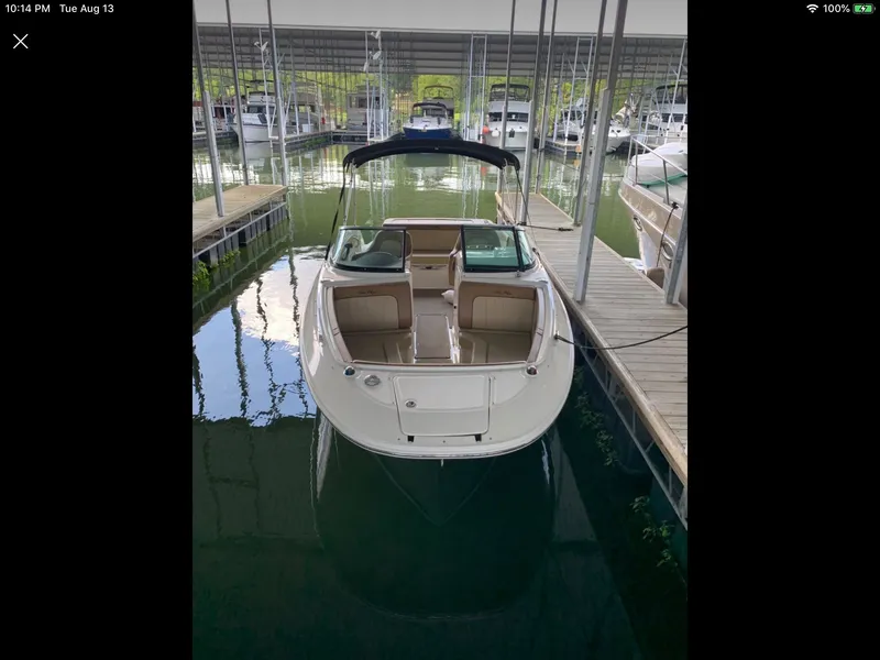 Slide: The Image of 2014 Sea Ray 220 Sundeck docked in a covered marina. - 3