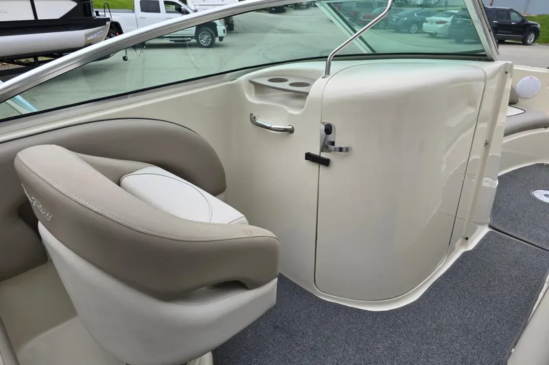 Slide: The Image of 2003 Sea Ray 220 Sundeck interior with beige seating and sleek design. - 14