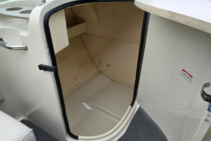 Slide: The Image of Storage compartment inside a 2003 Sea Ray 220 Sundeck boat. - 15