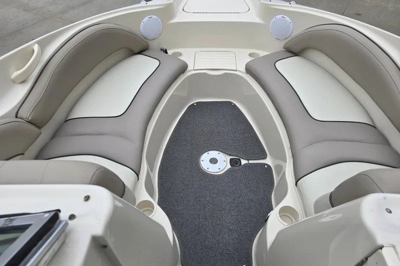Slide: The Image of Interior of a 2003 Sea Ray 220 Sundeck boat with cushioned seating and carpeted floor. - 16