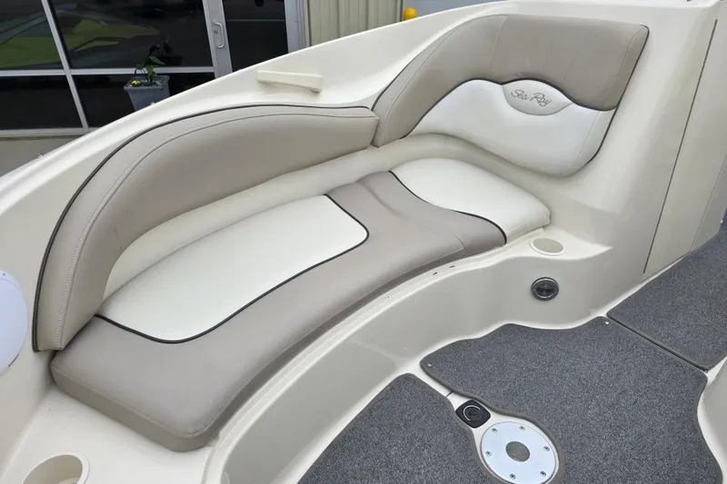 Slide: The Image of 2003 Sea Ray 220 Sundeck interior seating with beige and white upholstery. - 17