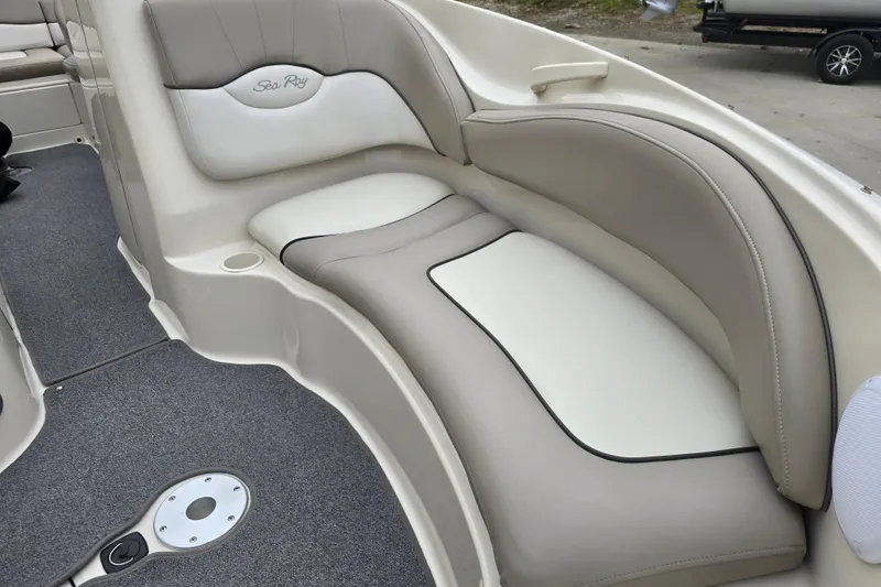 Slide: The Image of 2003 Sea Ray 220 Sundeck interior with beige and white cushioned seating. - 18