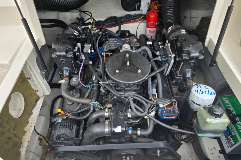 Slide: The Image of Engine compartment of a 2003 Sea Ray 220 Sundeck boat, showcasing detailed components. - 19