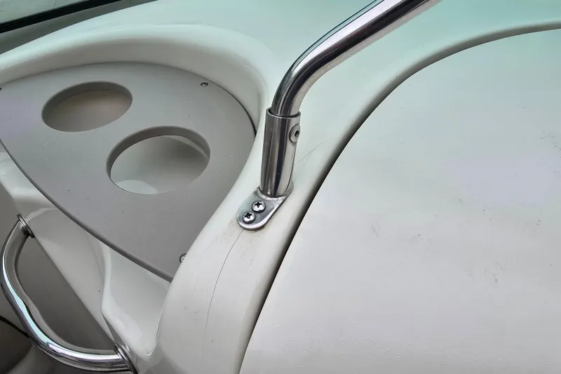 Slide: The Image of Close-up of 2003 Sea Ray 220 Sundeck boat's cup holders and railing. - 21