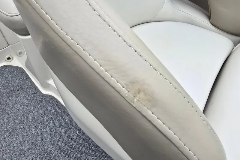 Slide: The Image of Close-up of 2003 Sea Ray 220 Sundeck's white leather seat with slight wear. - 25