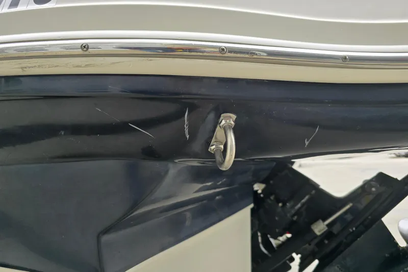 Slide: The Image of Close-up of a 2003 Sea Ray 220 Sundeck boat hull with visible scratches. - 27