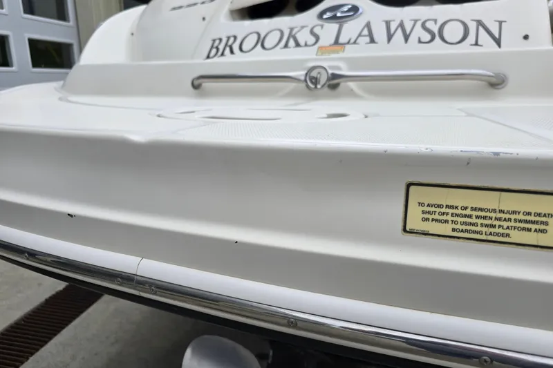 Slide: The Image of Rear view of a 2003 Sea Ray 220 Sundeck boat with safety warning label. - 29