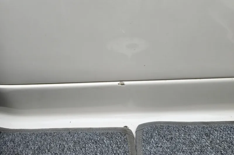Slide: The Image of Close-up of 2003 Sea Ray 220 Sundeck interior with minor damage. - 32