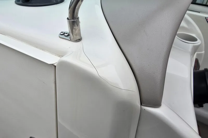 Slide: The Image of Crack on 2003 Sea Ray 220 Sundeck boat's white fiberglass surface. - 33