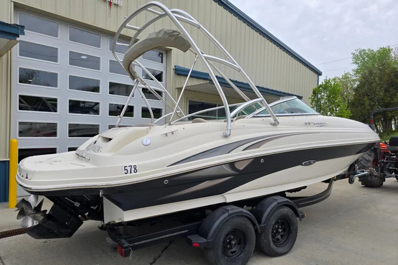 Slide: The Image of 2003 Sea Ray 220 Sundeck boat on trailer, parked outside a garage. - 4