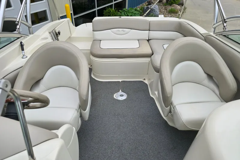 Slide: The Image of Interior of a 2003 Sea Ray 220 Sundeck boat with plush seating and steering wheel. - 8
