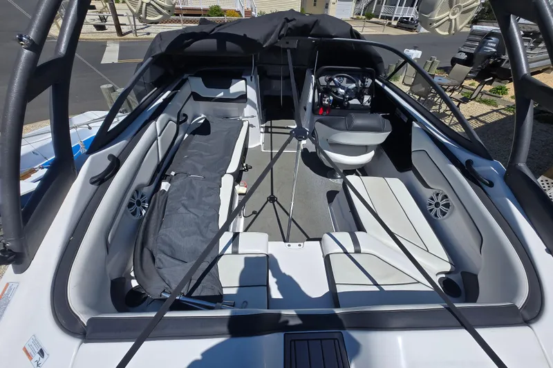 Slide: The Image of 2018 Yamaha Boats AR210 interior with seating and steering wheel, showcasing modern design. - 11