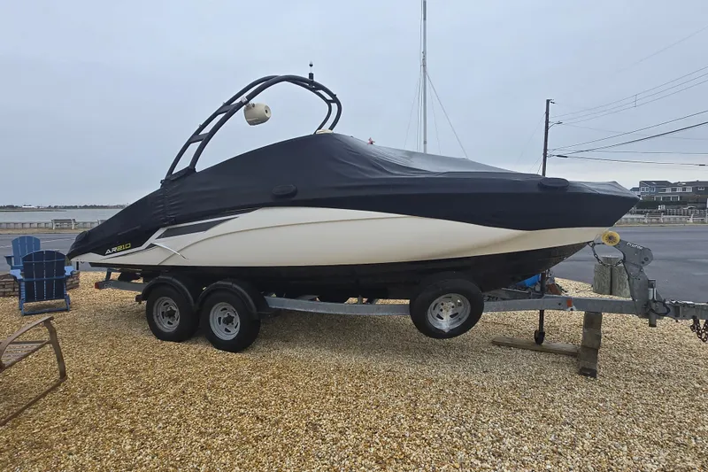 Slide: The Image of 2018 Yamaha AR210 boat on trailer, covered, parked near waterfront. - 13