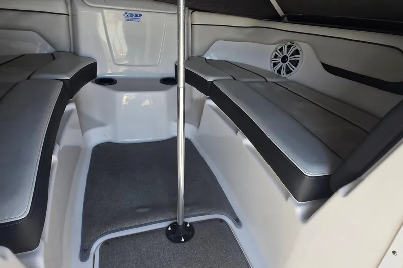 Slide: The Image of Interior of 2018 Yamaha Boats AR210, featuring cushioned seating and speaker system. - 20