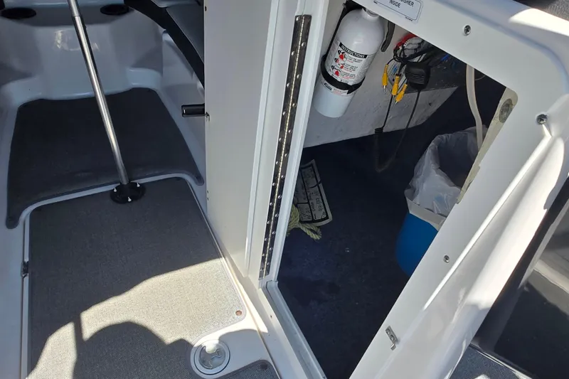Slide: The Image of Interior view of a 2018 Yamaha AR210 boat, featuring storage and safety equipment. - 22