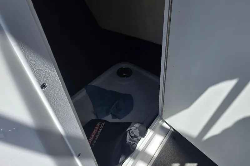 Slide: The Image of 2018 Yamaha AR210 boat interior storage compartment with items inside. - 23