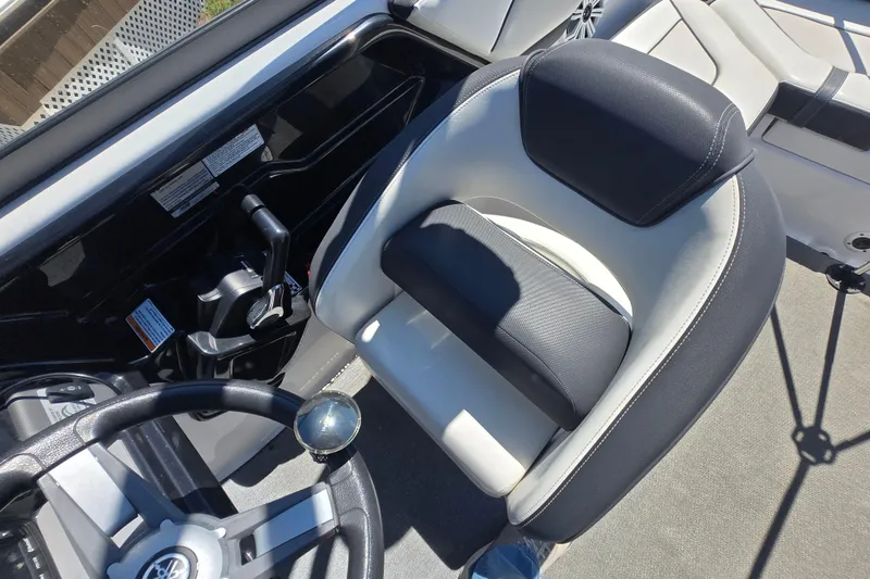 Slide: The Image of 2018 Yamaha AR210 boat cockpit with steering wheel and comfortable seating. - 26