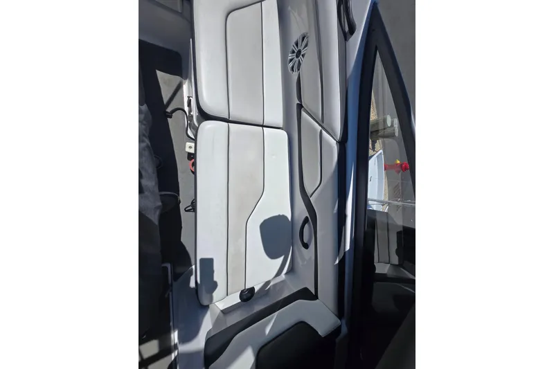 Slide: The Image of 2018 Yamaha Boats AR210 interior seating with sleek, modern design and speaker system. - 27