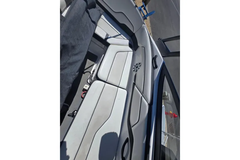 Slide: The Image of 2018 Yamaha AR210 boat interior with cushioned seating and speaker. - 28