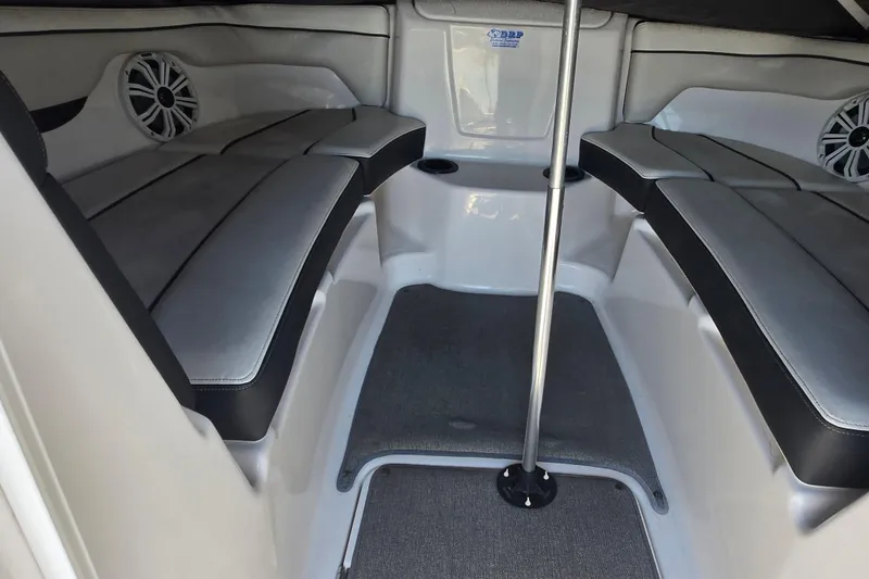 Slide: The Image of 2018 Yamaha Boats AR210 interior with cushioned seating and speaker system. - 7