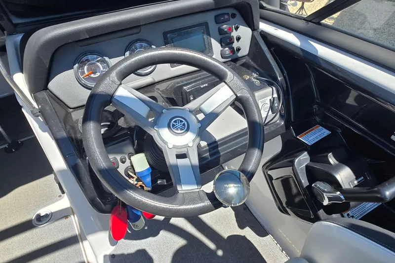 Slide: The Image of 2018 Yamaha AR210 boat dashboard with steering wheel and control panel. - 8