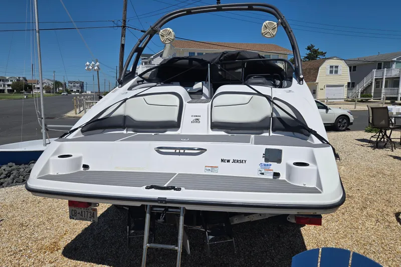 Slide: The Image of 2018 Yamaha Boats AR210 in New Jersey, parked on gravel, rear view. - 9