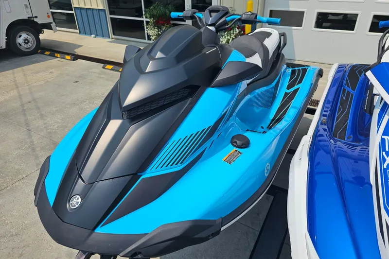 Slide: The Image of 2022 Yamaha WaveRunner GP1800R HO in vibrant blue, parked outdoors. - 4