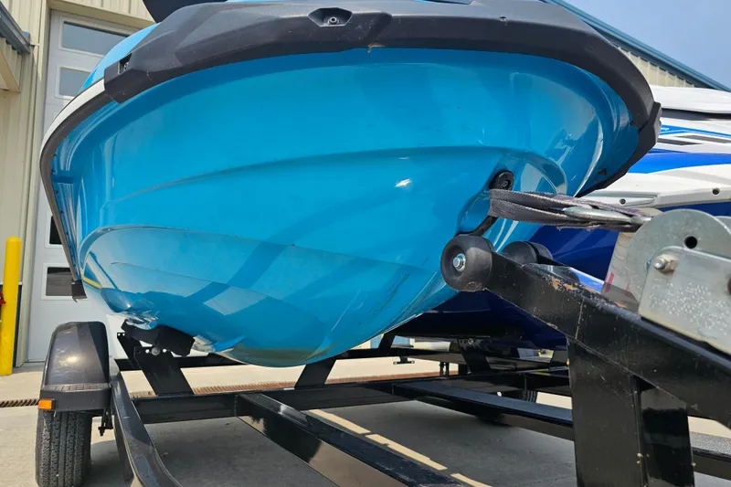 Slide: The Image of 2022 Yamaha WaveRunner GP1800R HO on trailer, vibrant blue hull, outdoor setting. - 6
