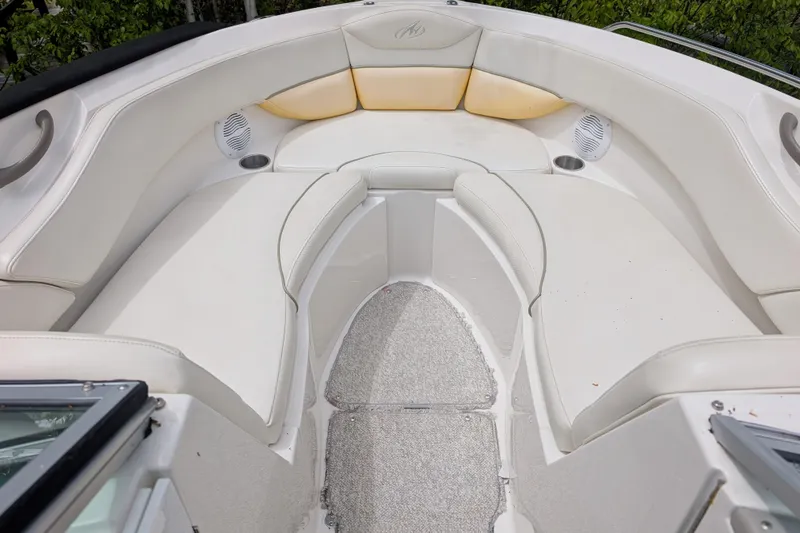 Slide: The Image of 2007 Monterey 248LS Montura Bowrider interior with white seating and speakers. - 2