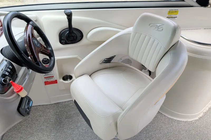Slide: The Image of 2007 Monterey 248LS Montura Bowrider cockpit with steering wheel and white captain's chair. - 3