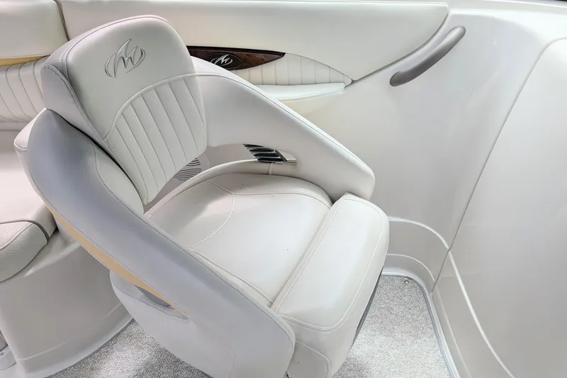 Slide: The Image of Luxurious seating in a 2007 Monterey 248LS Montura Bowrider boat, featuring elegant white upholstery. - 5