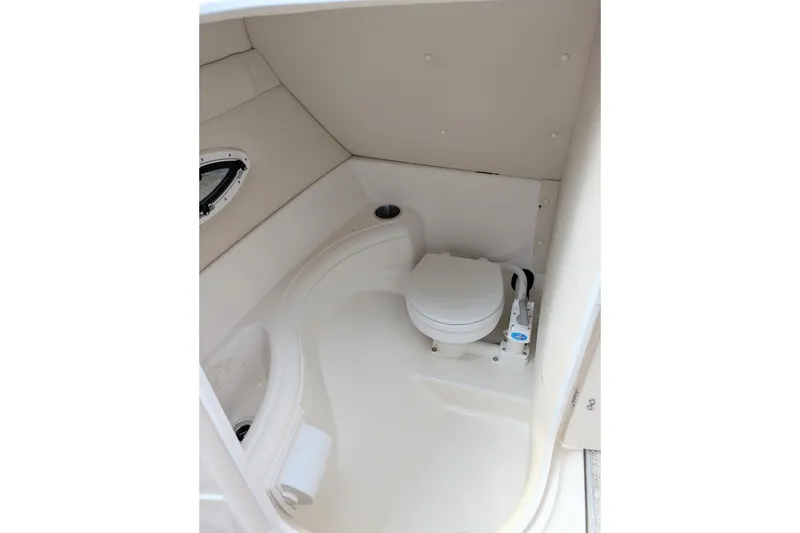 Slide: The Image of 2007 Monterey 248LS Montura Bowrider boat bathroom interior with toilet and porthole. - 6
