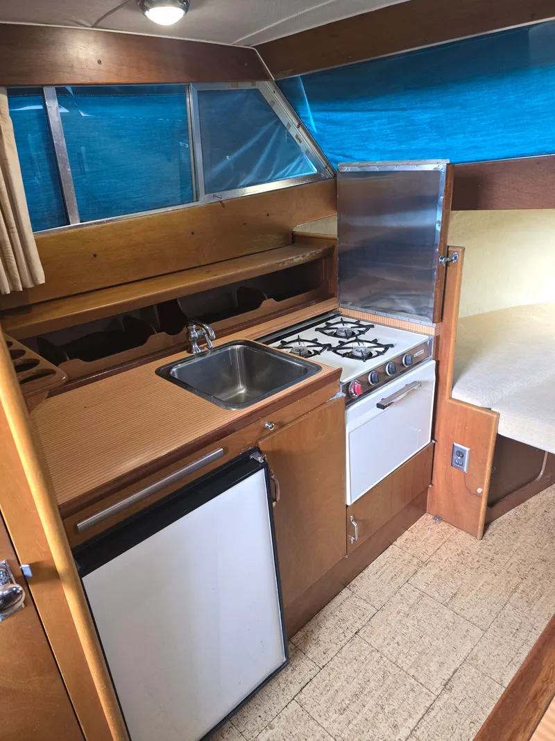 Slide: The Image of Interior of 1968 Tollycraft Royal Express with kitchen and stove. - 19
