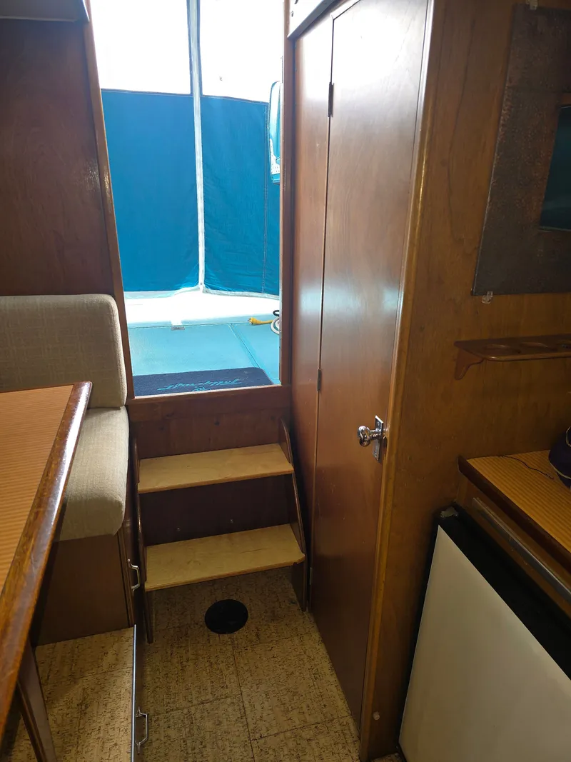 Slide: The Image of Interior of a 1968 Tollycraft Royal Express yacht with wooden furnishings. - 25