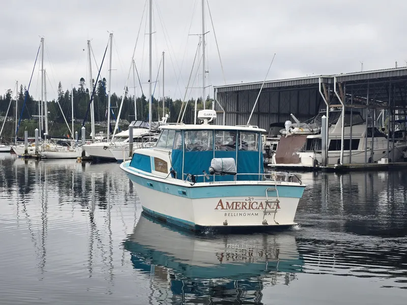 Slide: The Image of 1968 Tollycraft Royal Express in harbor with sailboats. - 3