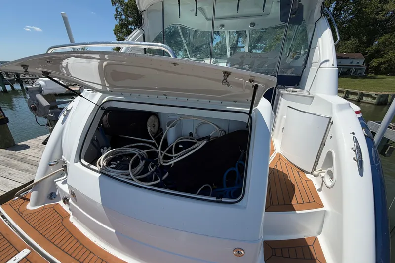 Slide: The Image of 2011 Formula 45 Yacht with open storage compartment, docked by the water. - 10
