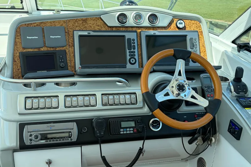 Slide: The Image of Control panel of a 2011 Formula 45 Yacht with advanced navigation systems and steering wheel. - 14