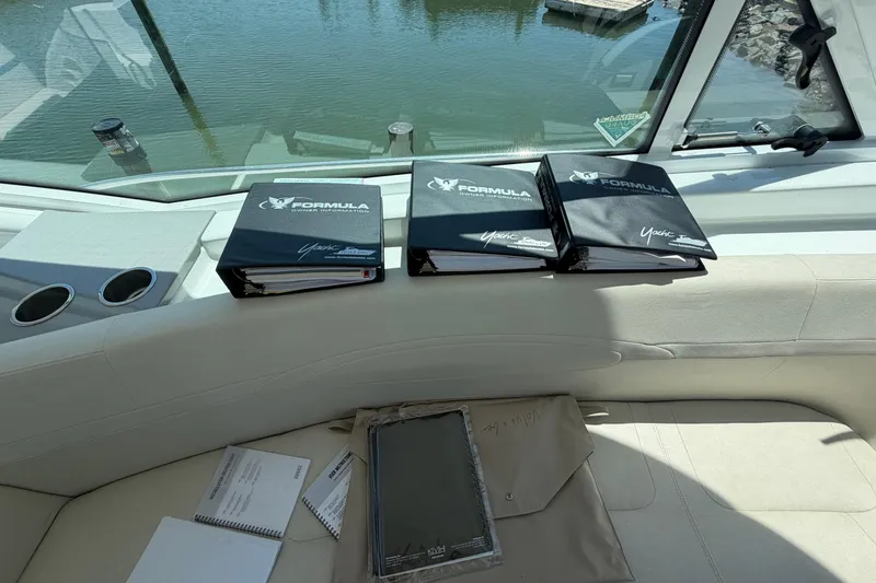 Slide: The Image of Binders and manuals on a 2011 Formula 45 Yacht interior, overlooking water. - 19